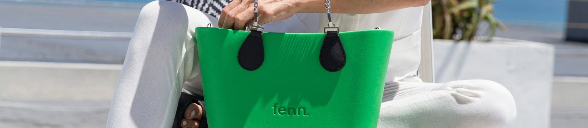 Woman holding green Fenn bag